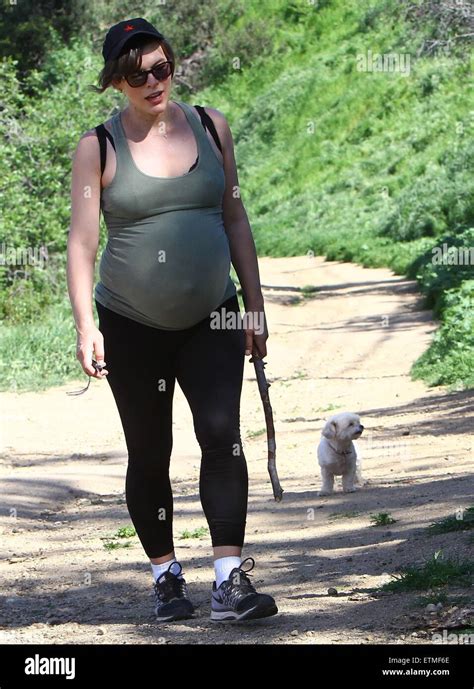 Heavily Pregnant Milla Jovovich And Her Husband Paul Go For A Walk With