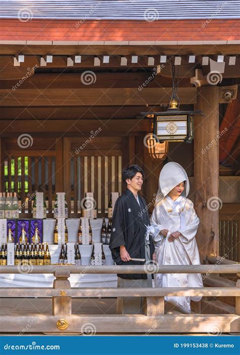 japanese shinto wedding of a couple in kimono under a lantern of the meiji shrine editorial