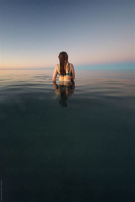 Teenage Girl Viewed From Behind Standing In Waist Deep Ocean Water