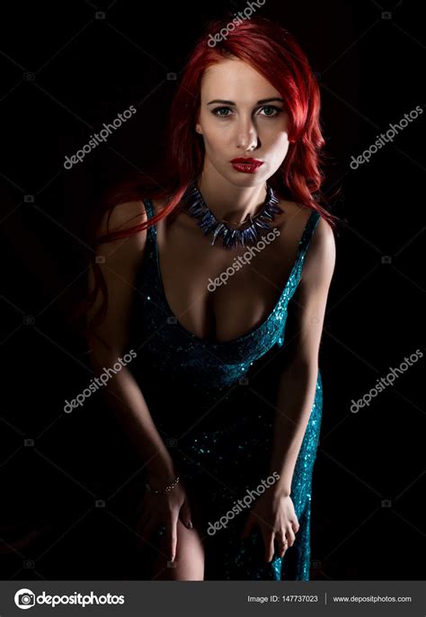 Beautiful Redhead Woman With Big Tits In A Tight Dress Posing On A Dark