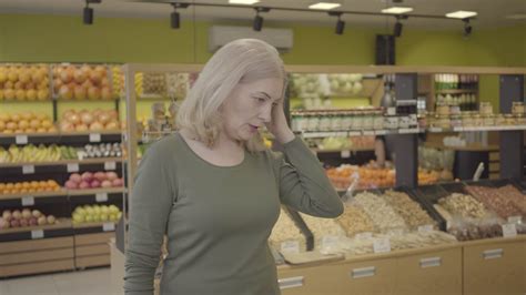 Senior Caucasian Blond Woman Choosing Purchases In Grocery Portrait Of Housewife Buying