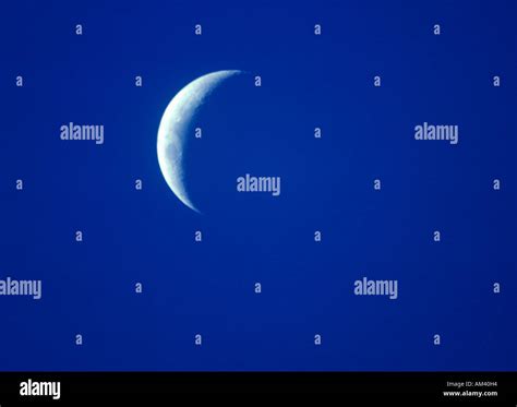 A Crescent Moon Against A Deep Blue Twilight Sky Stock Photo Alamy