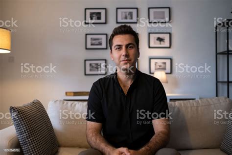 Headshot Portrait Millennial Guy Sit On Sofa Makes Video Call Stock
