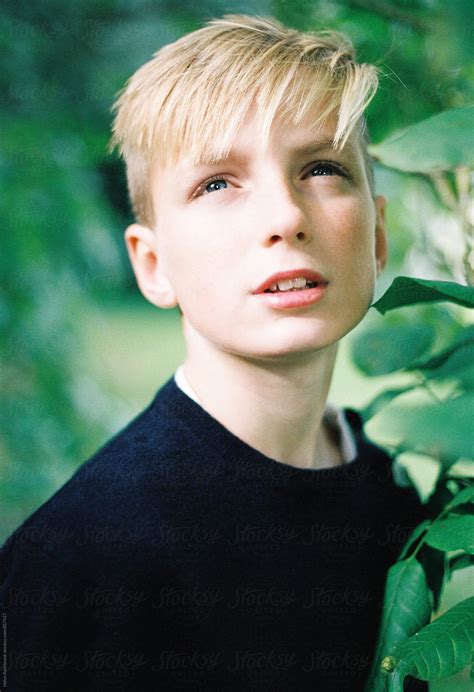 Portrait Of A Teenage Boy Outdoors Looking Away By Stocksy Contributor Helen Rushbrook