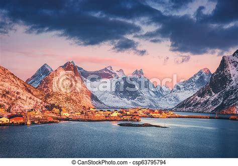 Reine Village And Snow Covered Mountains At Beautiful Sunrise In Winter