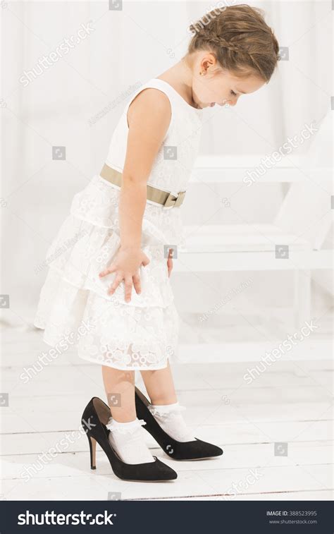 Adorable Cute Caucasian Girl Wearing White Dress And Black