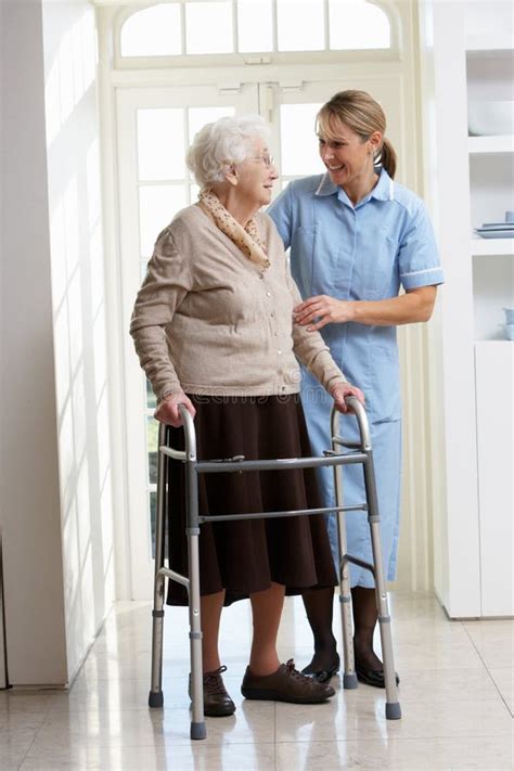 Carer Helping Elderly Senior Woman Using Walking F Stock Image Image