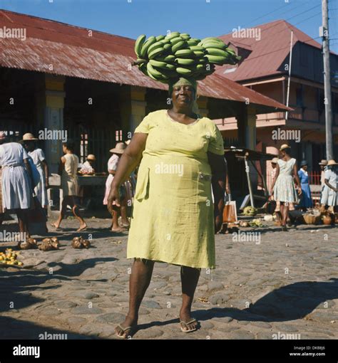 Dominica Caribbean Roseau Market Woman Carrying A Large Stalk Of