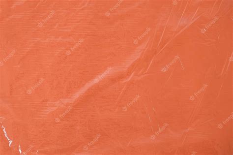 Textura De Plástico Transparente Arrugada Sobre Un Fondo Naranja