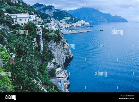 Buildings Overlooking The Cliff With The City Of Amalfi In The
