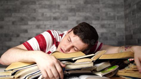Man Student With A Lot Of Books Preparing For Exams Fell Asleep On The