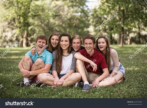 Group Of Young White People Sitting Outdoors Stock Photo 223373389