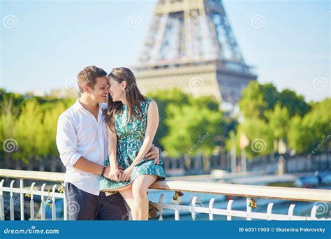 Young Romantic Couple Having A Date Near The Eiffel Tower Stock Photo