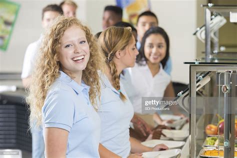 High School Students Choosing Healthy Foods In Cafeteria Lunch Line