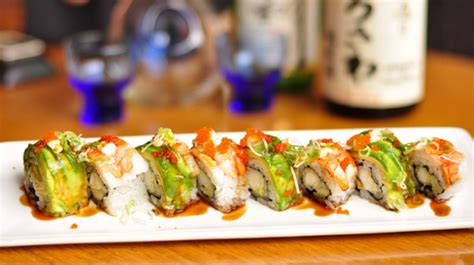 Azuma roll inside with tuna, salmon, yellowtail, white tuna, cucumber, avocado, wrapped with soy bean seaweed, topped with kani salad. New Japanese restaurant in Houston's Midtown