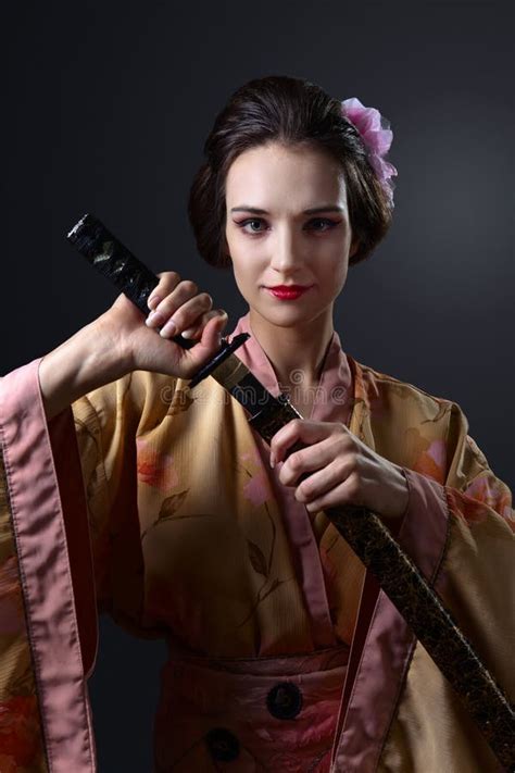 Beautiful Woman In Traditional Japanese Kimono With Katana Stock Image
