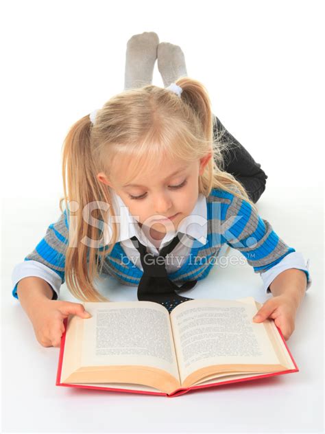 Seven Year Old Student Reading Book On Floor Stock Photo Royalty