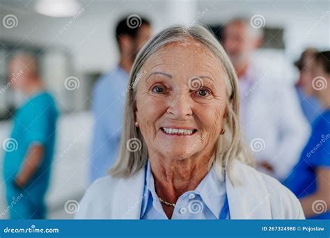 Portrait Of Elderly Doctor At Hospital Corridor Stock Photo Image Of