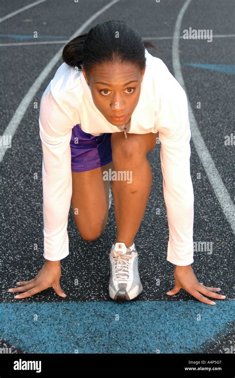 Black African American Woman At The Starting Line Of A Track And Field