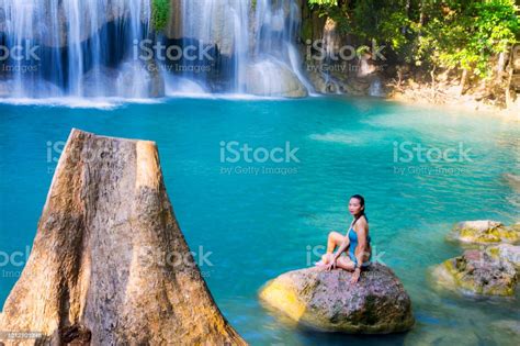 Woman In Blue Swimsuit Sit Enjoy At Erawan Waterfall And Natural Stock