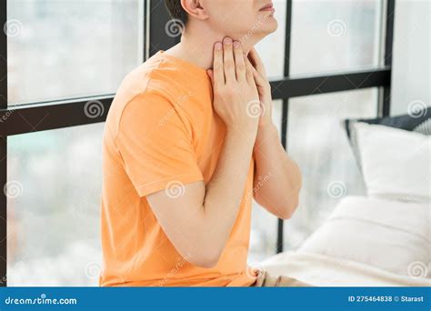 Sore Throat And Cough Man With Pain In Neck At Home Stock Photo