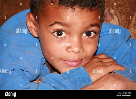 Young Mixed Race Boy With Chin On Hands Stock Photo Alamy