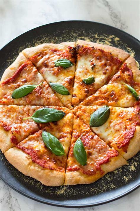 Make a simple pizza base, then top with tomato pizza sauce and mozzarella. Homemade Margherita Pizza