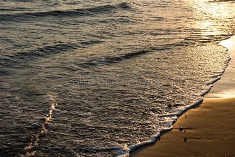 Waves Approaching Sandy Beach During The Sunset Stock Photo Image Of
