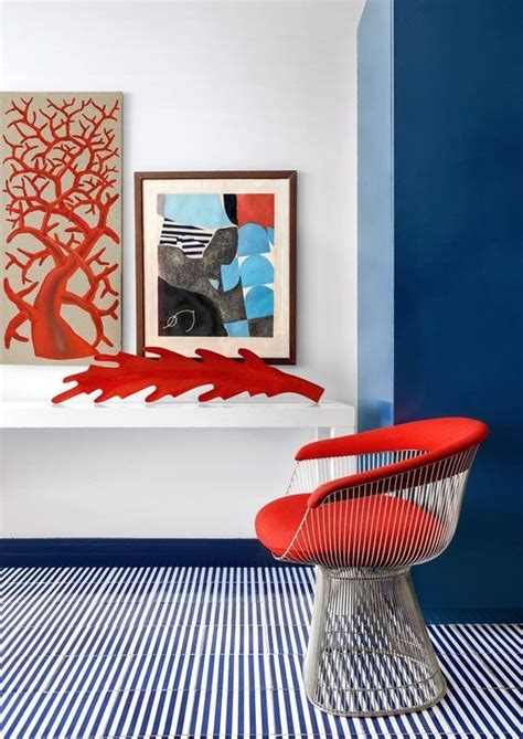 A Red Chair Sitting Next To A Blue Wall