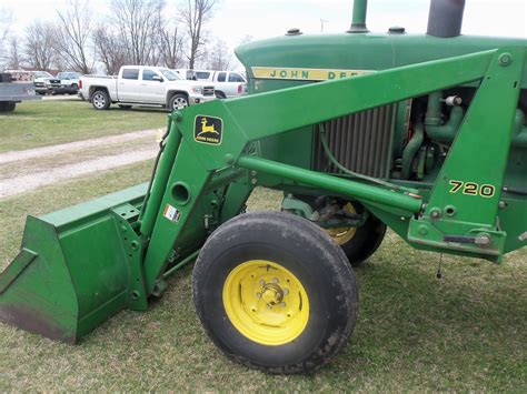On The Front Of The John Deere 4020 Is A Large Durable 720 Loader