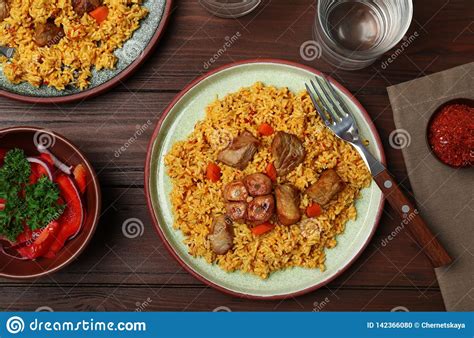 Flat Lay Composition With Plate Of Rice Pilaf And Meat Stock Photo