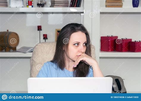 Thoughtful Woman Working On Computer Looking Away Thinking