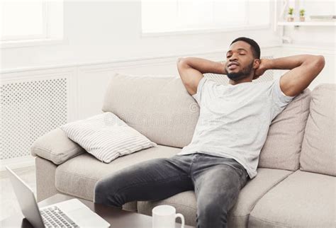 Handsome Young African American Man Relaxing On The Couch At Home Stock Image Image Of