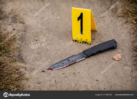 Crime Scene Investigation Bloody Knife With Crime Markers On Th