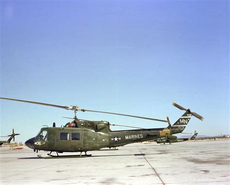 A Left Side View Of A Marine Uh 1n Iroquois Huey Helicopter Sitting On The Flight Line The