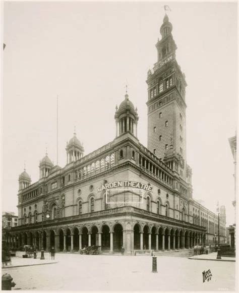 An Old Black And White Photo Of A Building With A Clock Tower In The Center