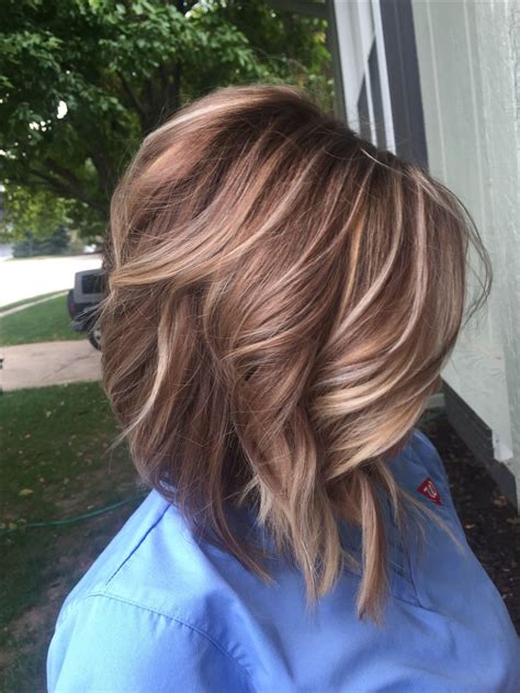 Using a mixture of highlights and lowlights, usually starting from the ear and finishing at the tips, a balayage is the perfect example of a hair hue that can be tailored to everyone. Lob. Lowlights highlights. Blonde and brown. Carmel ...
