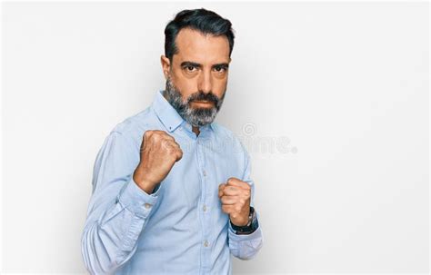 Middle Aged Man With Beard Wearing Business Shirt Ready To Fight With