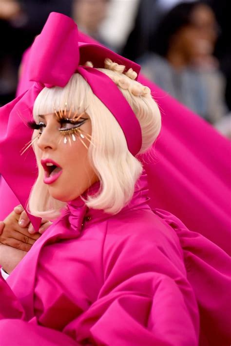 Lady In Bright Pink Outfit With White Hair And Black Eyeliners On Her Face
