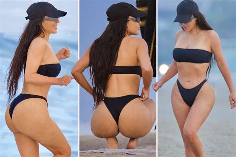 kim kardashian shows off bare butt in tiny black thong bikini as she hits the beach with