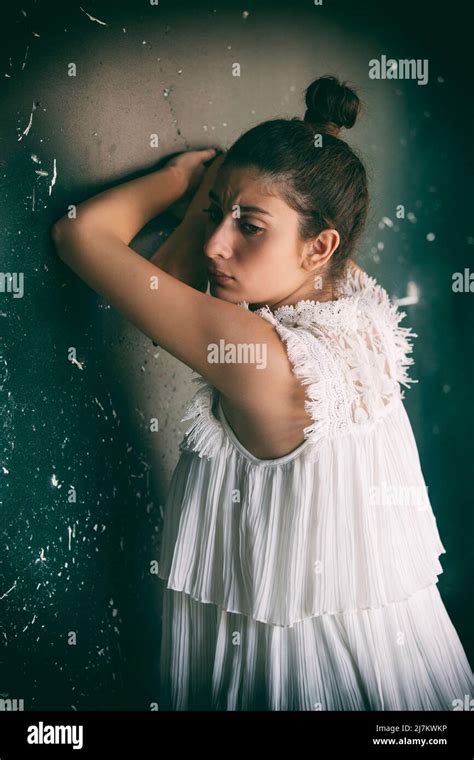 Sad Woman Leaning Against The Wall Stock Photo Alamy