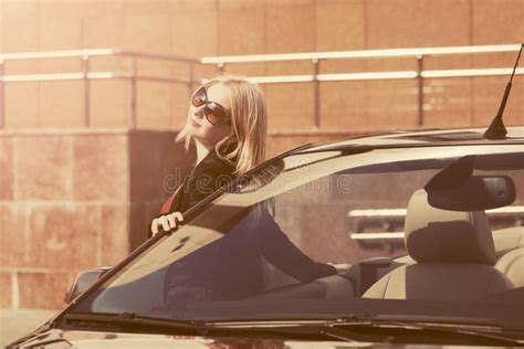 Young Fashion Woman In Sunglasses Leaning On Her Convertible Car Stock