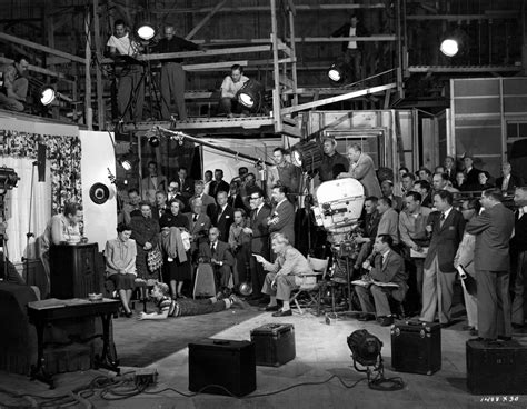 Black And White Photograph Of People In An Industrial Setting With Lights On The Ceiling One