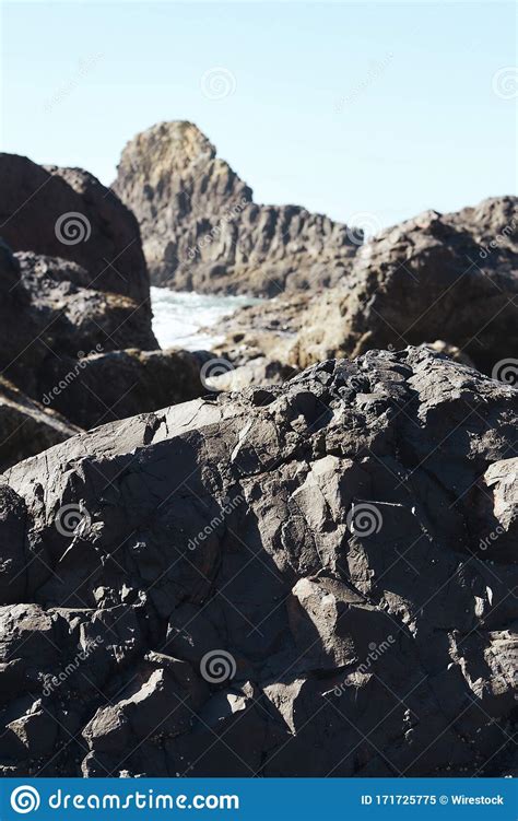 Vertical Shot Of Rocks At The Coastline Of The Pacific Northwest In