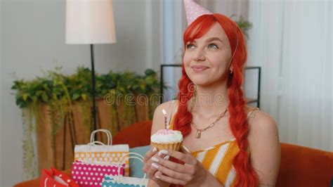 Happy Redhead Woman Celebrating Birthday Party Makes Wish Blowing Burning Candle On Small