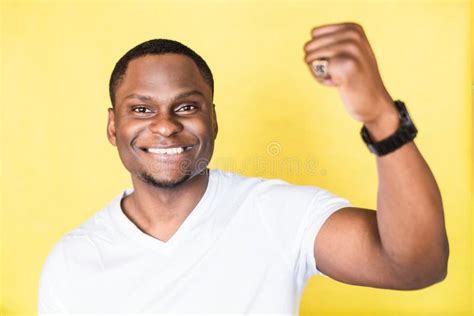 Portrait Of A Smiling African American Man With Raised Hand Stock