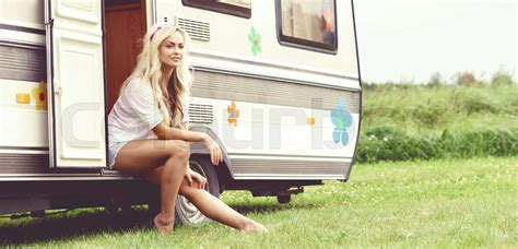 Young And Beautiful Hippy Girl Sitting On Trailer At Summer Holiday