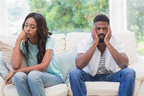 Couple Having Argument On Couch Stock Photo By ©wavebreakmedia 81754948