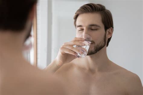 Young Man Drink Mineral Water In Bathroom Stock Photo Image Of Care