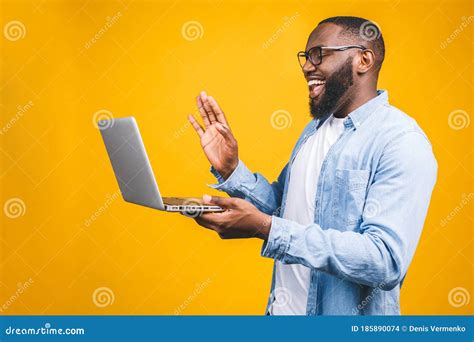 Young Happy Smiling African American Man Standing And Using Laptop